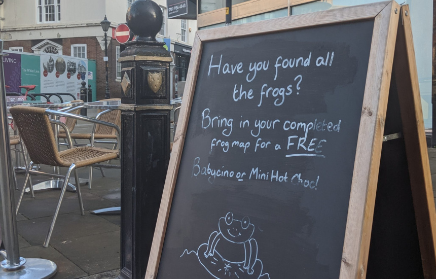 Café sign promoting the frogs